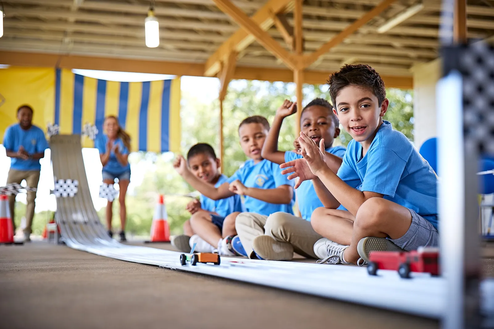 Cub Scouts cheering at the Pinewood Derby track