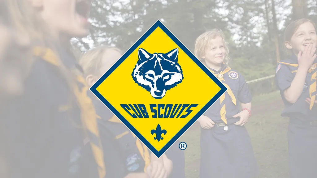 Cub Scouts in uniform outdoors, with the Cub Scouts emblem